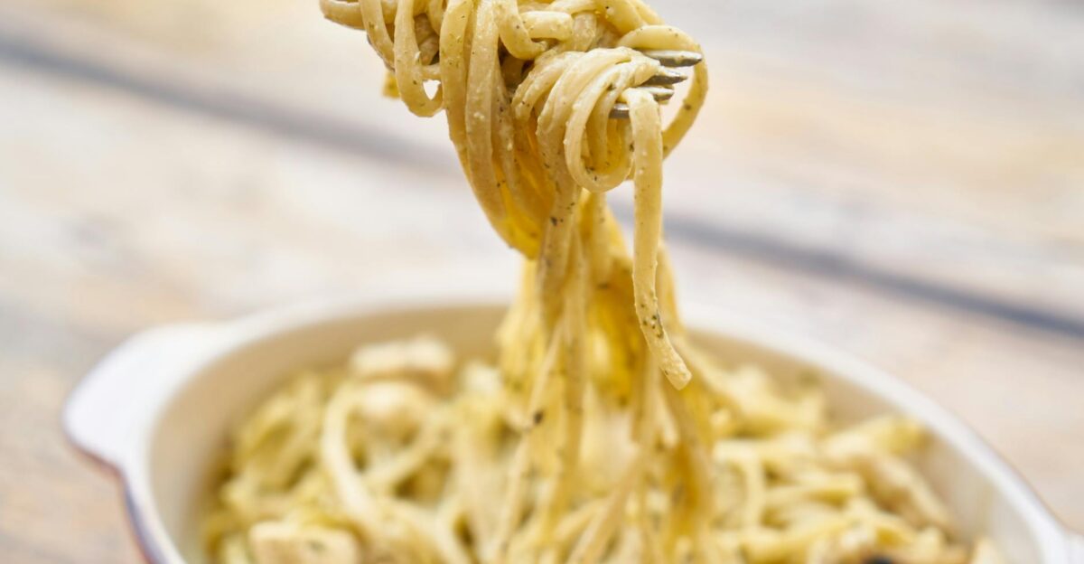 A close-up of creamy Italian pasta with basil and cheese perfect for a delicious meal