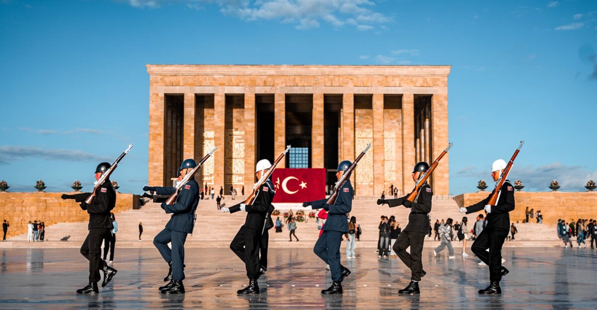 Soldiers performing a ceremonial march at An tkabir with Turkish flag in the background