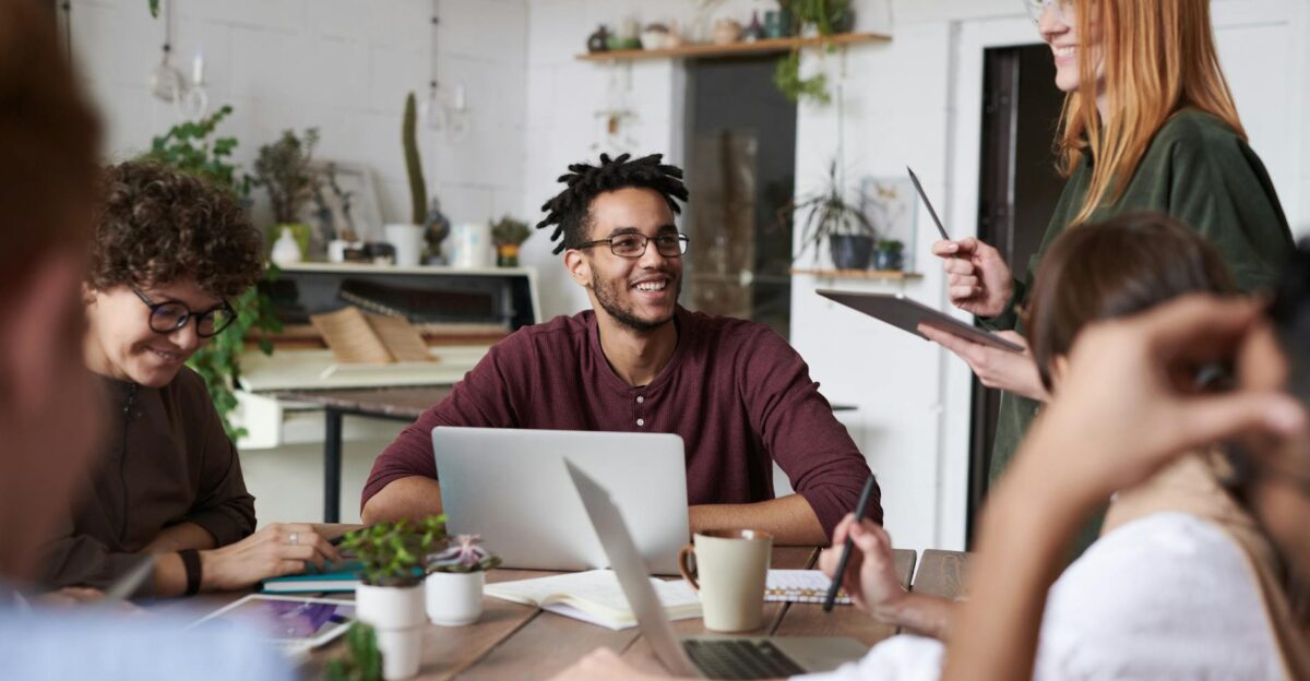 A diverse group of professionals engaging in a productive team meeting in a modern office space