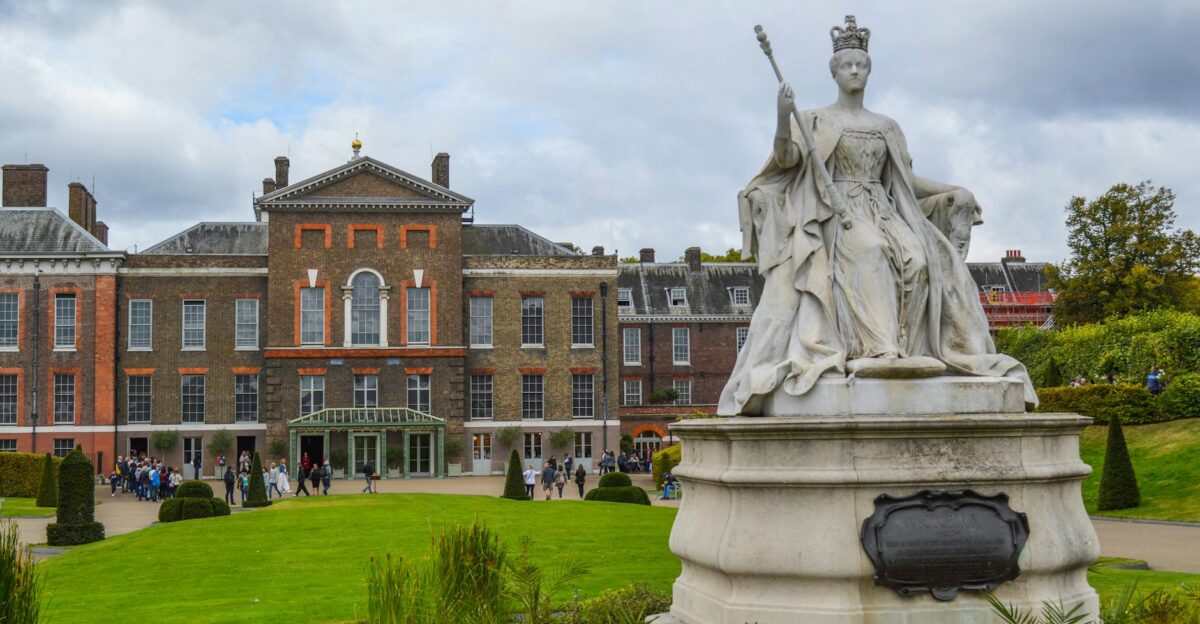 Kensington Palace with Queen Victoria statue showcasing British heritage and architecture