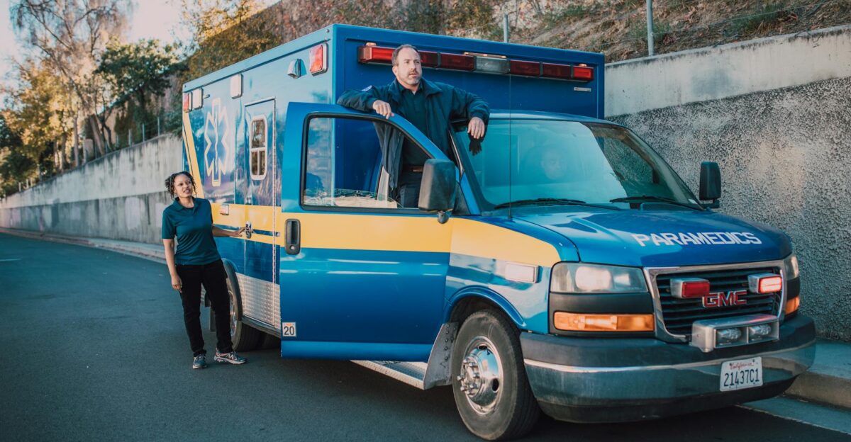 Ambulance with paramedics ready for an emergency response on a sunny day