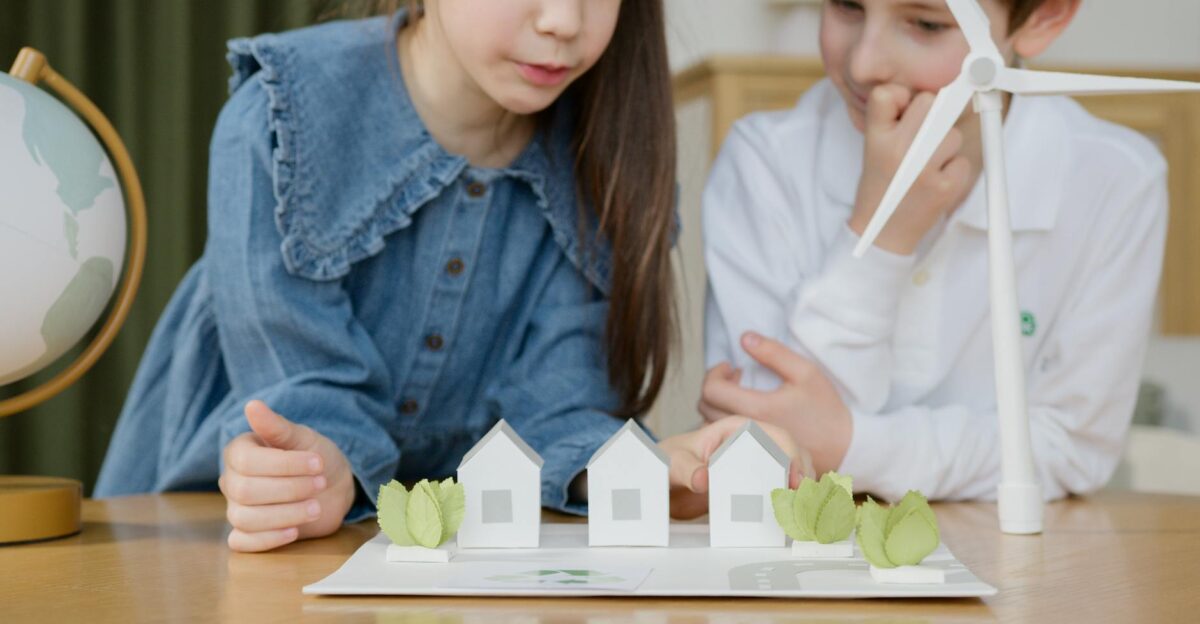 Children exploring wind energy models with a globe fostering environmental awareness