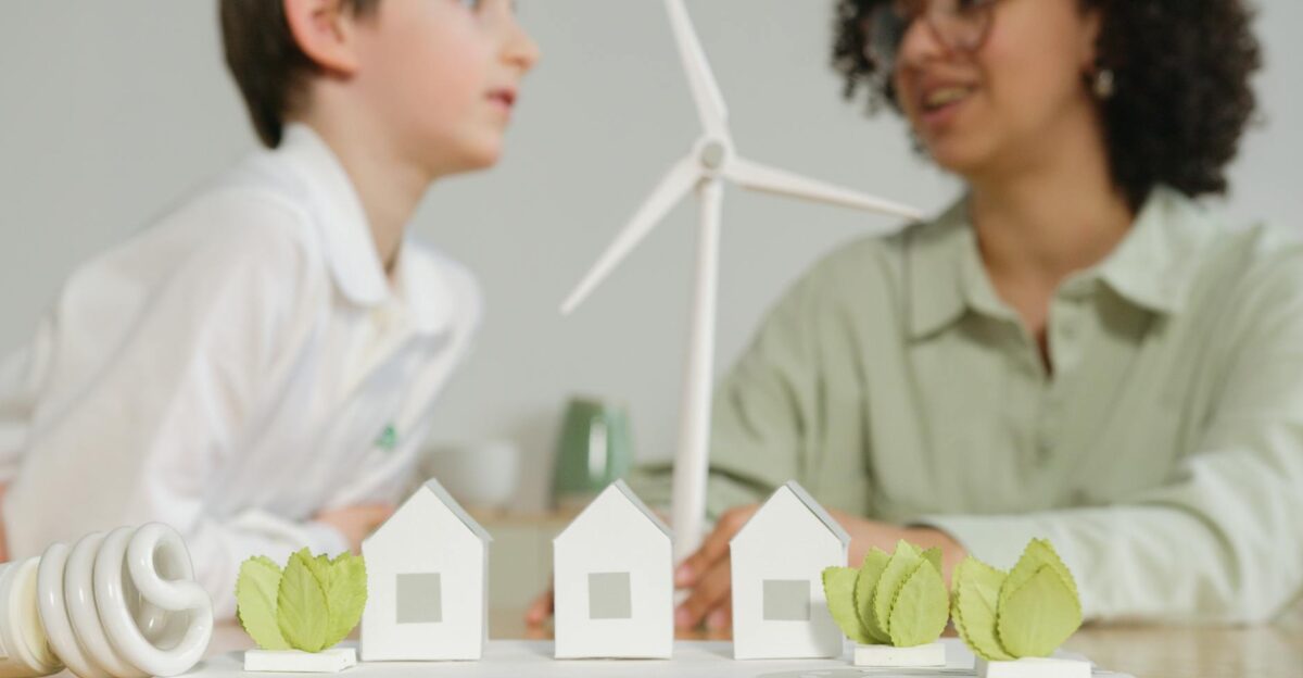 Children engage in learning about renewable energy with wind turbines and eco-friendly models in a classroom setting