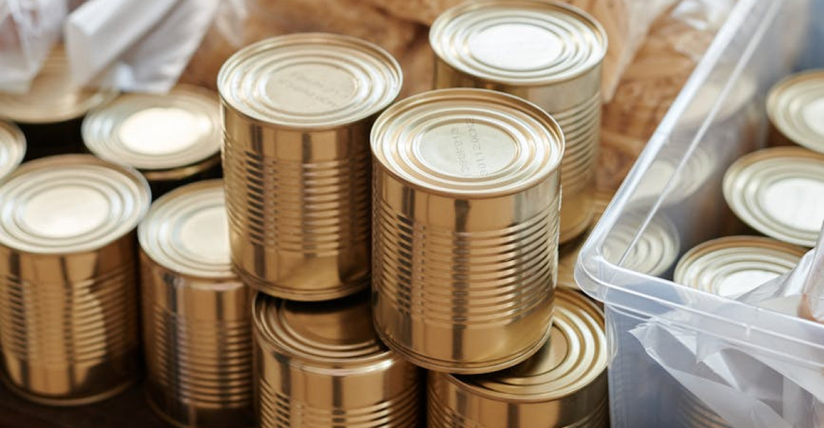 A variety of canned goods and packaged items arranged for a donation drive or food bank collection