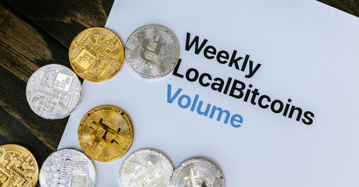 Image of Bitcoin tokens on a Weekly LocalBitcoins volume report paper