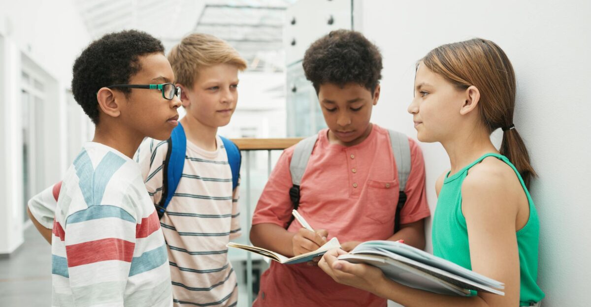 A group of multicultural students discussing and studying together indoors