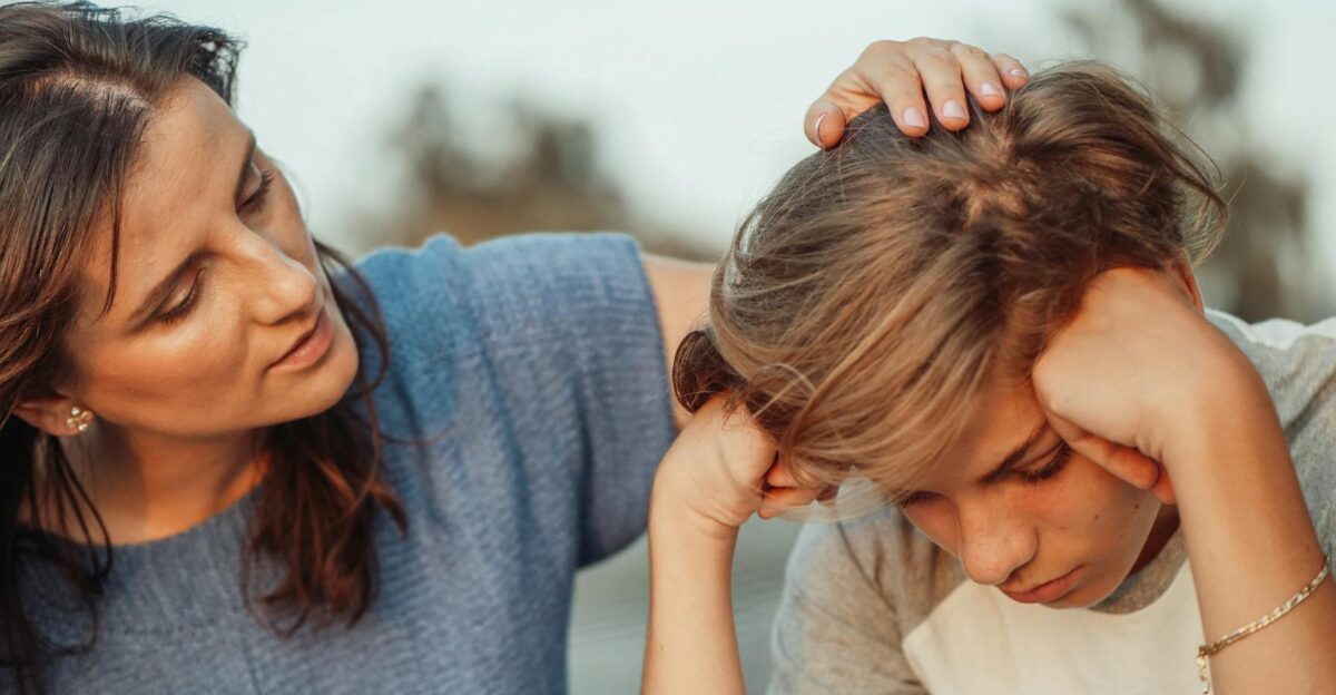 A mother offers support to her discouraged teenager son portraying love and understanding