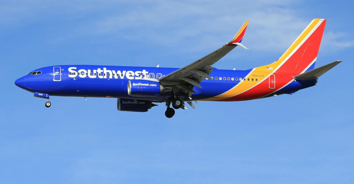 A vibrant Southwest Airlines airplane flying against a clear blue sky showcasing its colorful livery