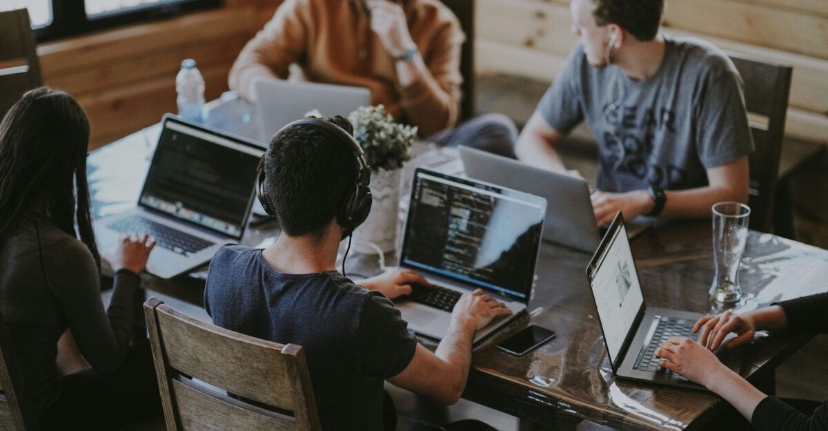 group of people using laptop computer