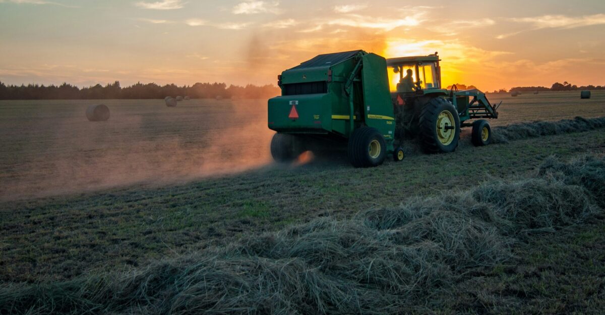 green farm heavy equipment on green field