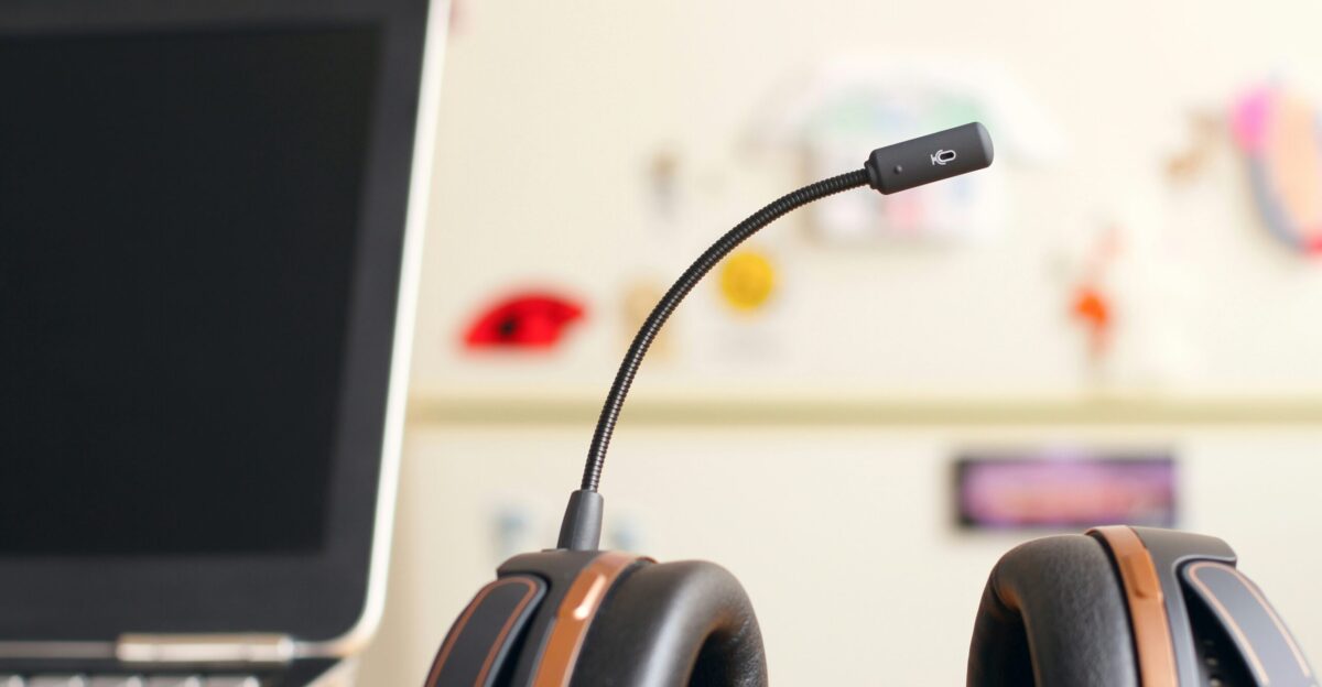 black and brown headset near laptop computer