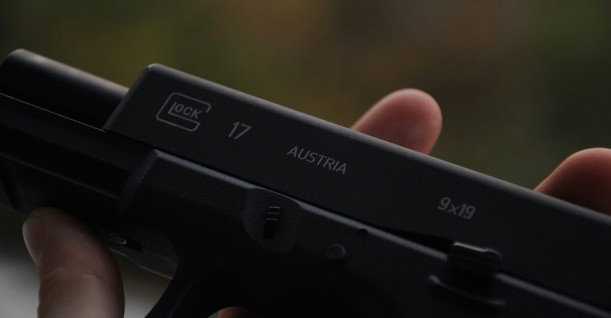 person holding black semi automatic pistol