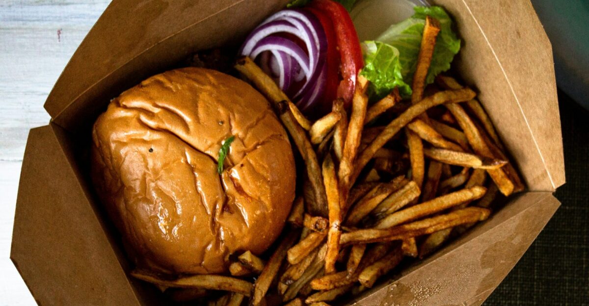 burger and fries on brown paper bag