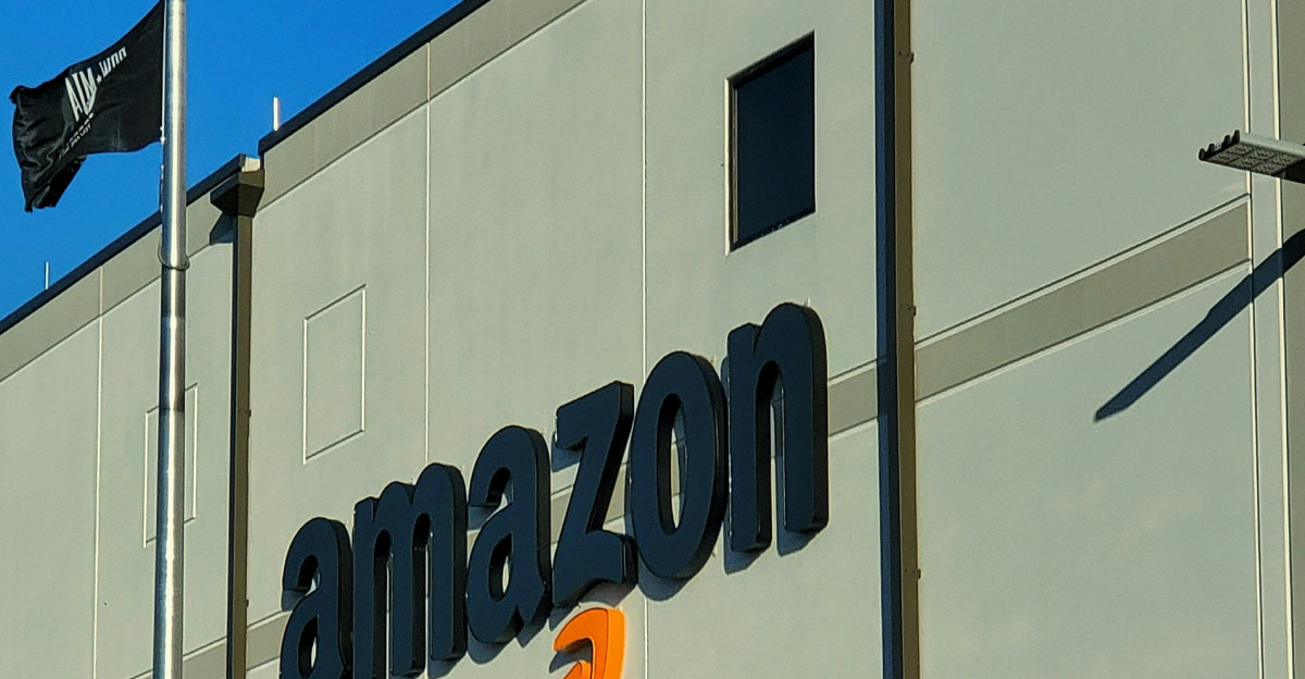 an amazon store with a person sitting in front of it