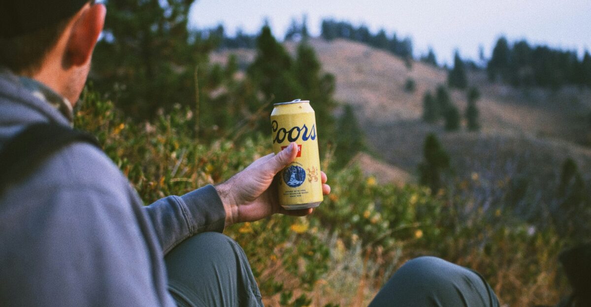 person holding white and brown ceramic mug