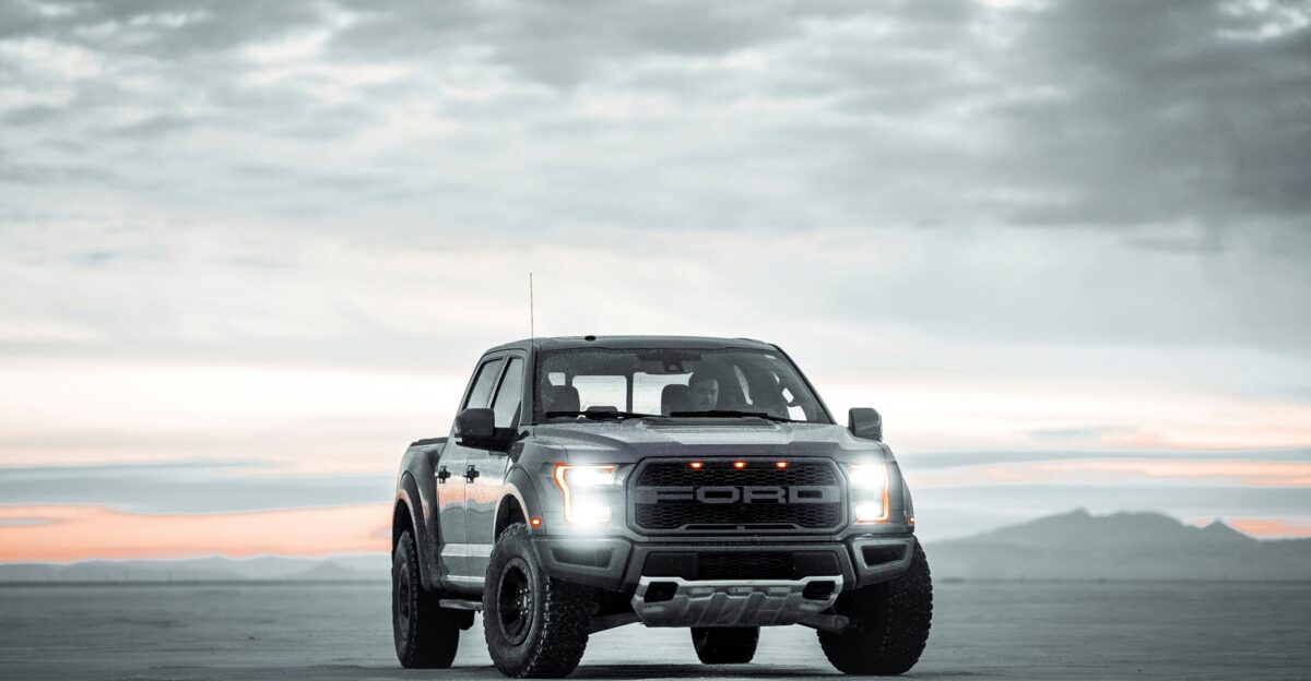 black chevrolet crew cab pickup truck on gray sand during daytime