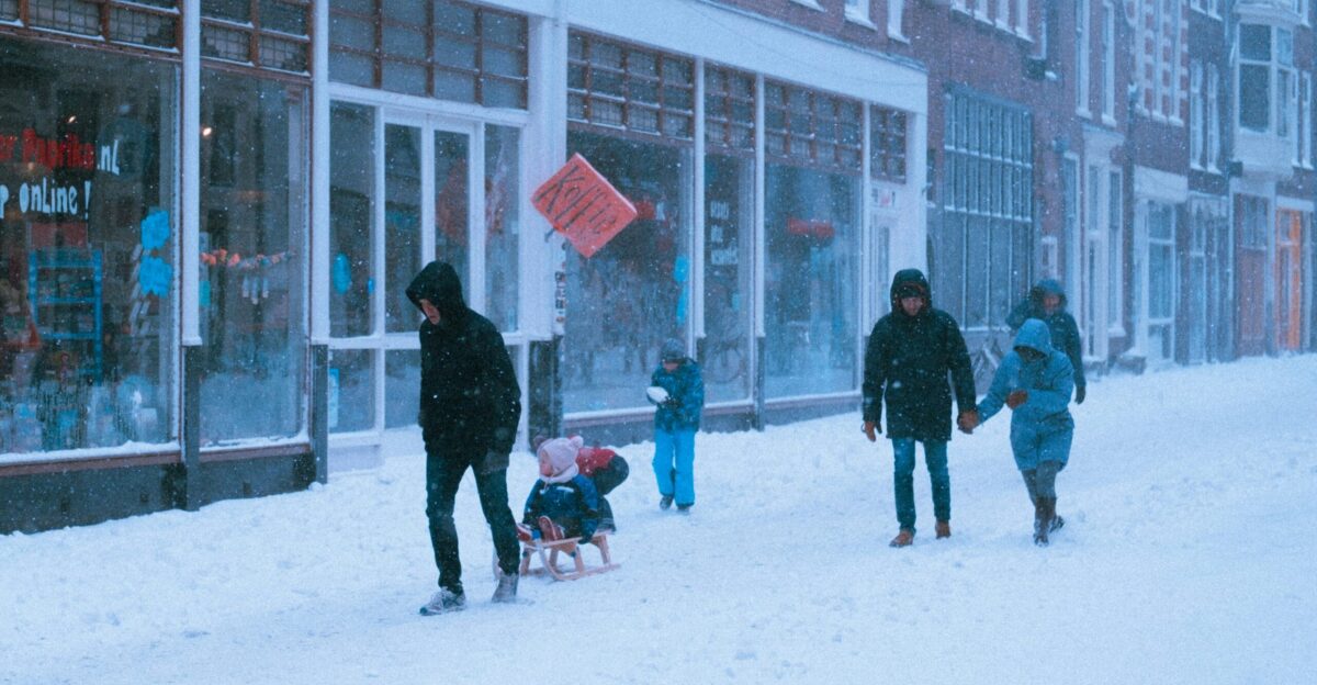 people walking on snow covered ground during daytime