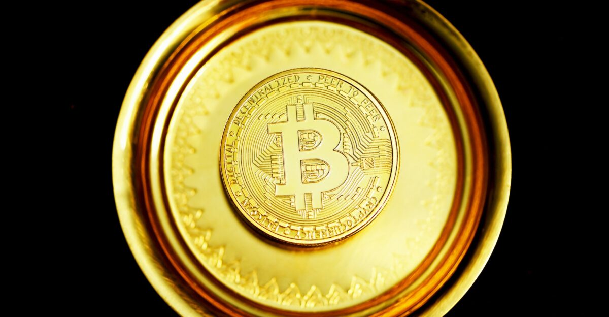 gold round coin on black surface