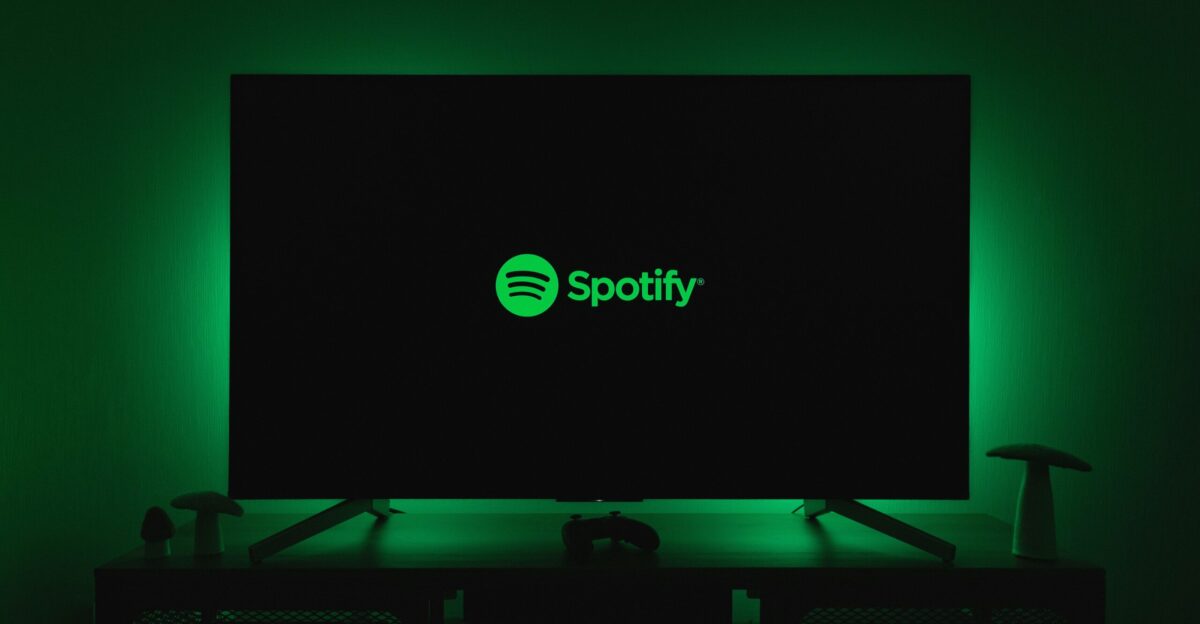 the spotify logo is lit up on a flat screen tv