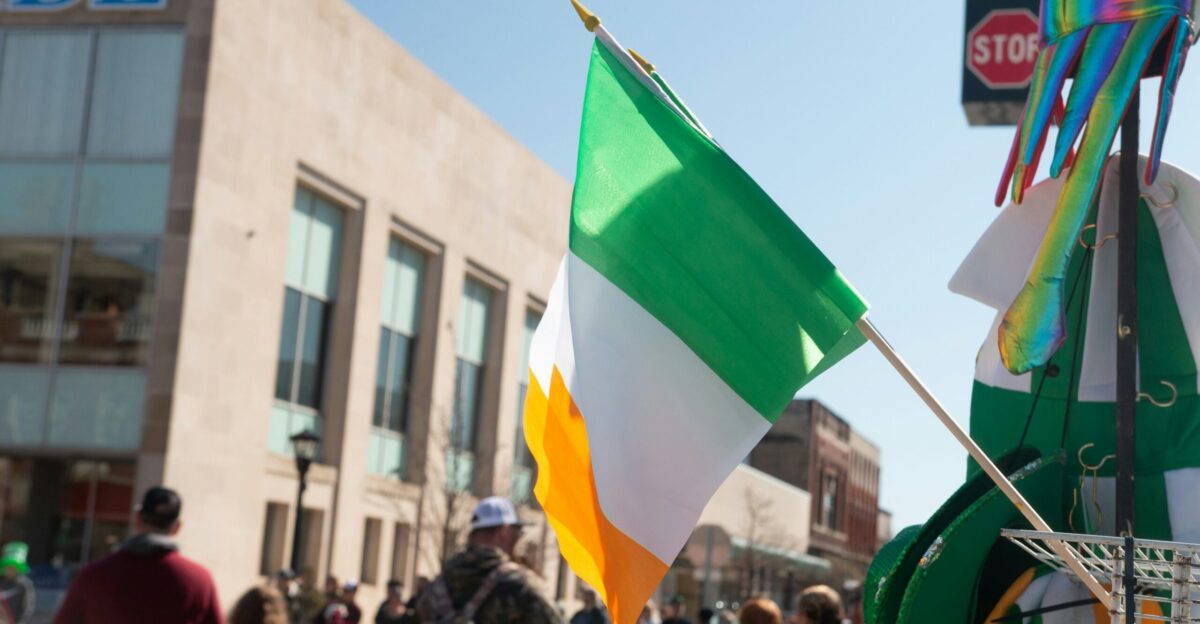 a group of people walking down a street holding flags