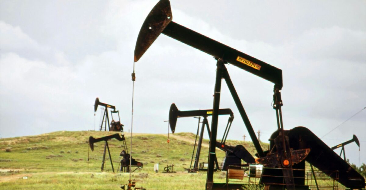 a group of oil pumps sitting on top of a field