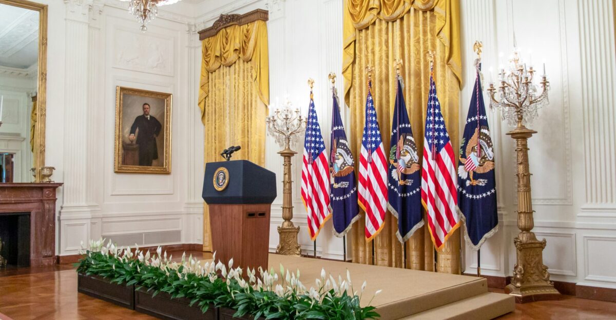a podium with flags in a room