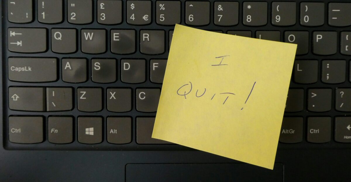 a yellow notepad on a keyboard