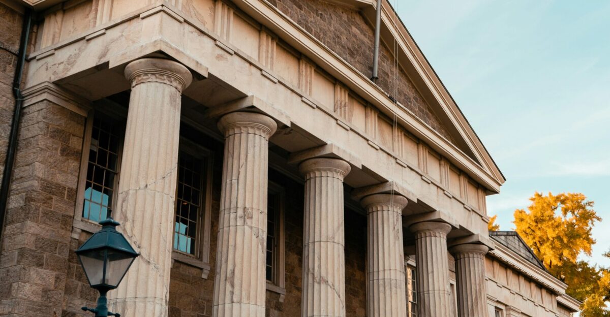 a building with columns and a flag on top