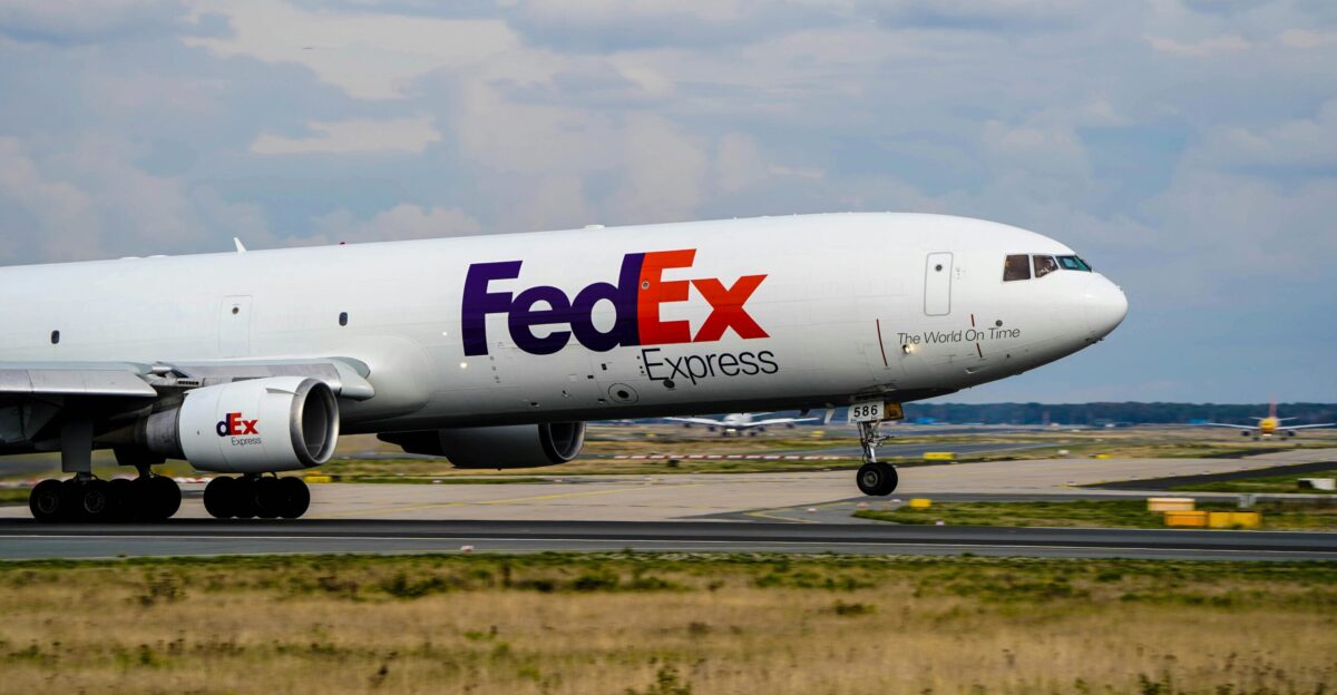 a fed ex airplane is on the runway