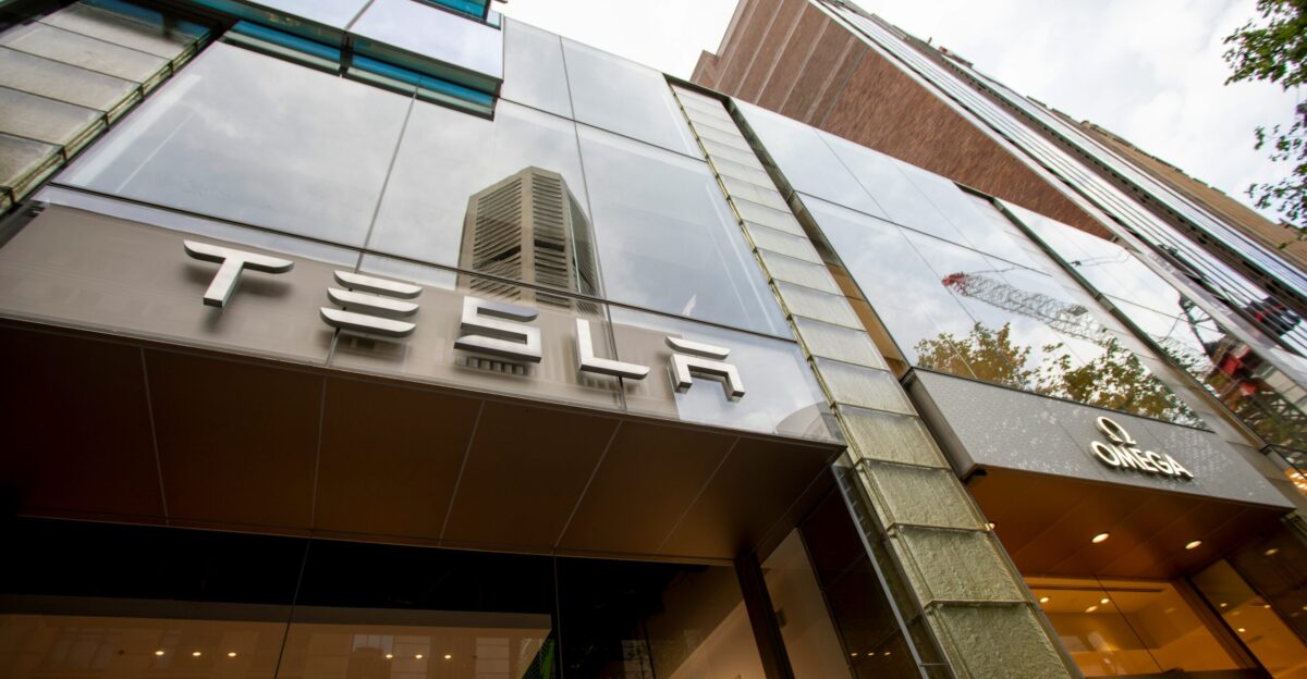 a tall building with a tesla sign on it s side