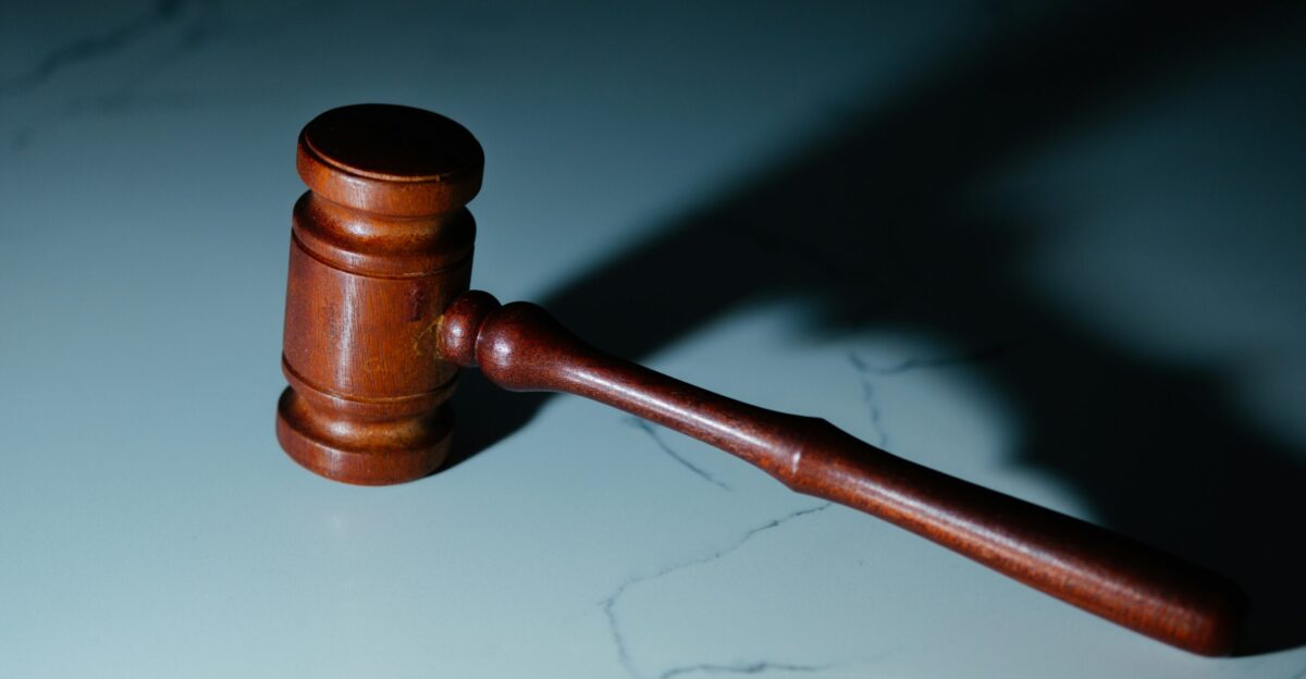 a wooden judge s hammer sitting on top of a table