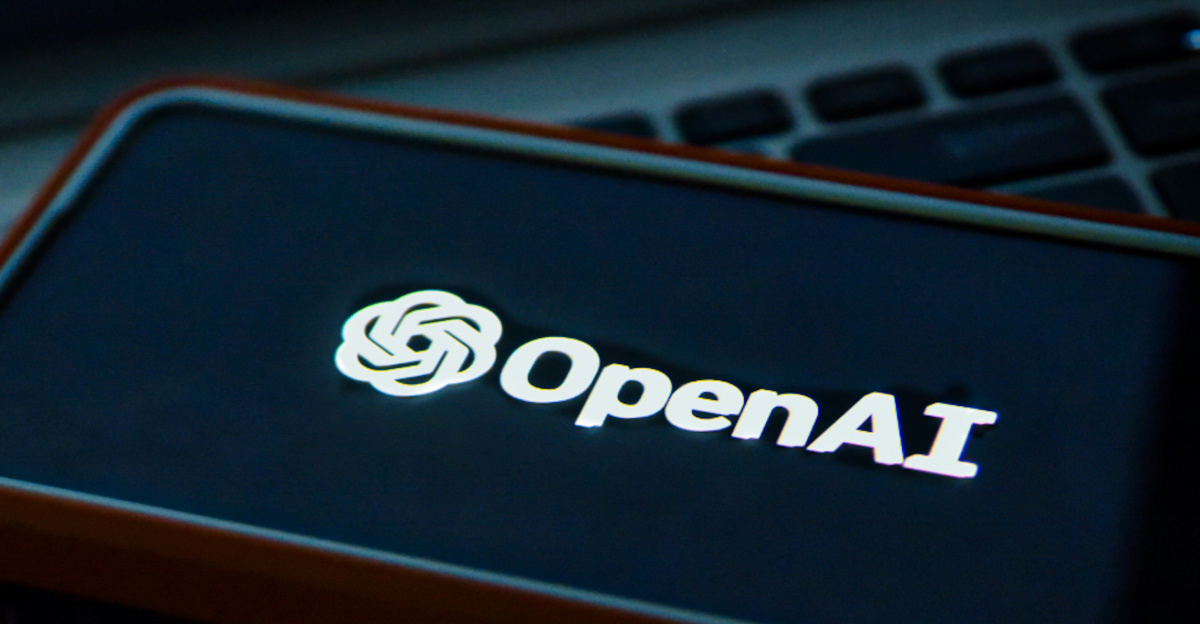 a cell phone sitting on top of a laptop computer