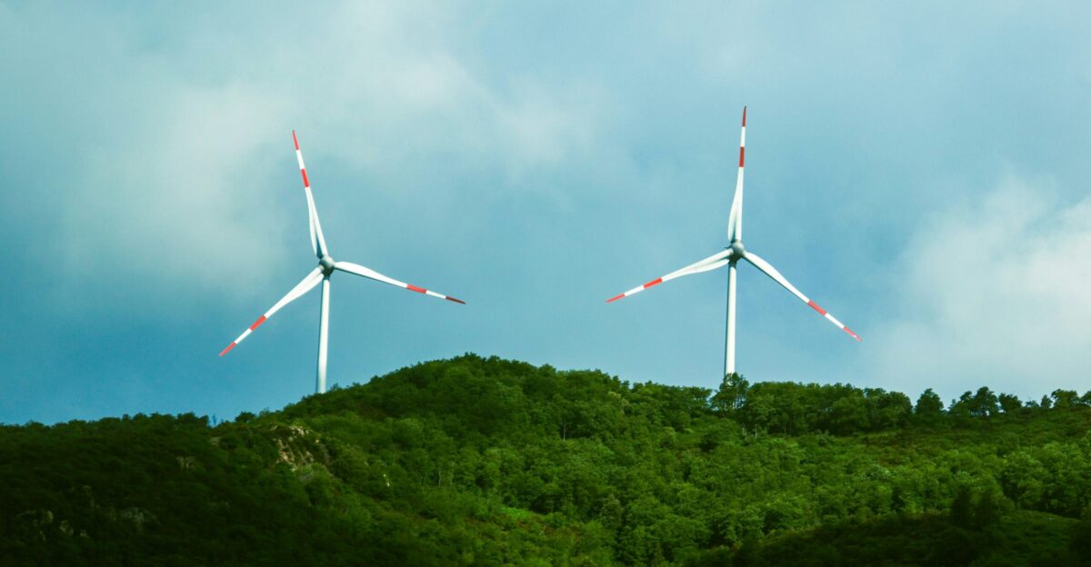 a couple of windmills that are on a hill