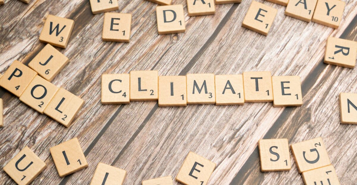 scrabble tiles spelling climate on a wooden surface