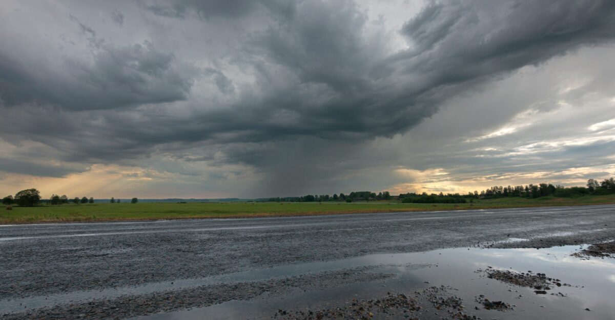 a road with a puddle of water in the middle of it