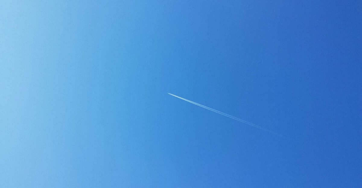 an airplane is flying high in the sky