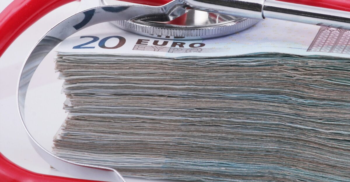 a stethoscope resting on top of a stack of money