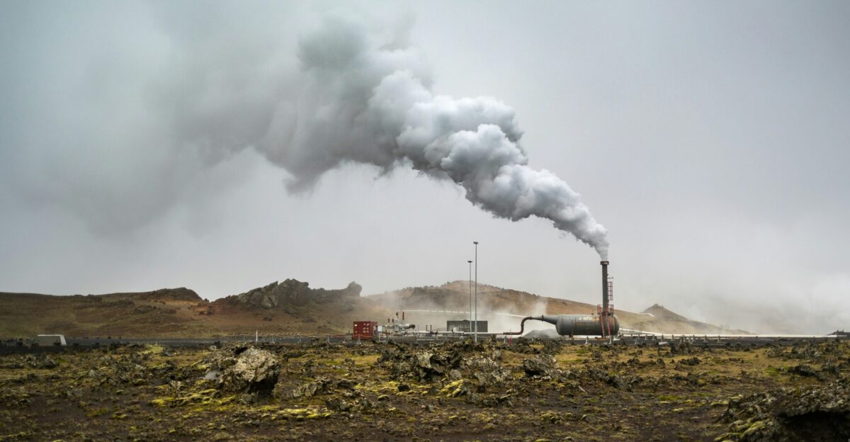 a large pipe emits smoke into the sky