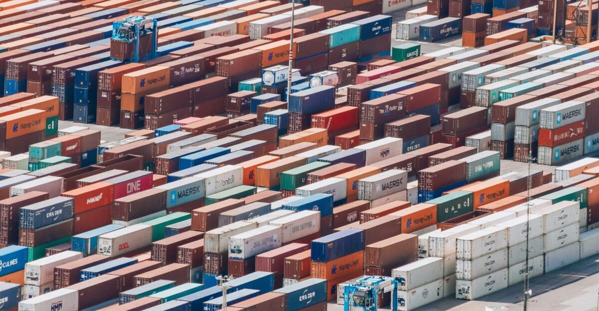 a large amount of cargo containers are stacked together