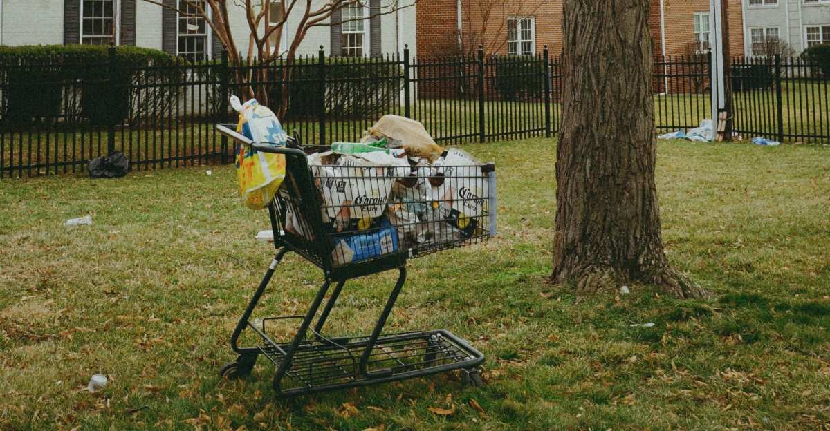 A baby stroller in a grassy area next to a tree