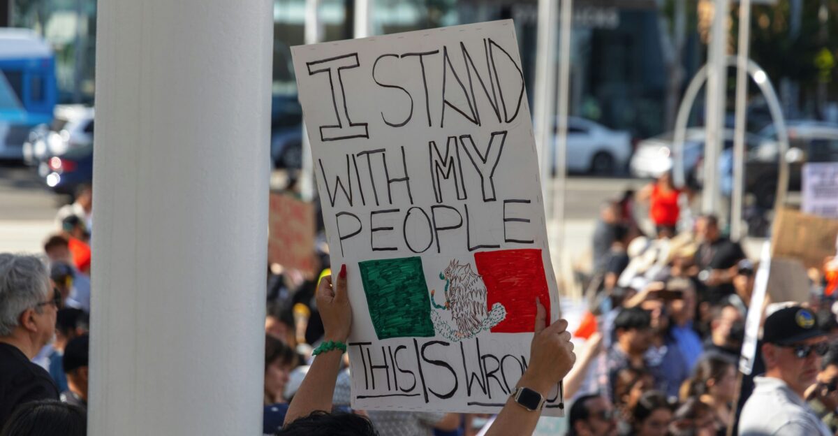 Protester holds a sign reading i stand with my people