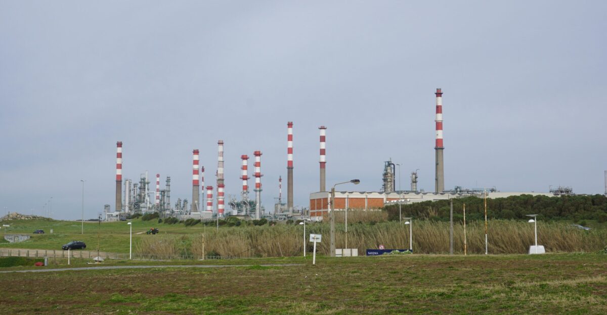 An industrial plant with chimneys and infrastructure is visible