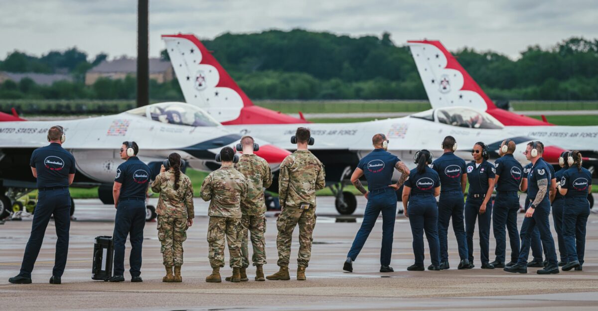Air force personnel stand by jets