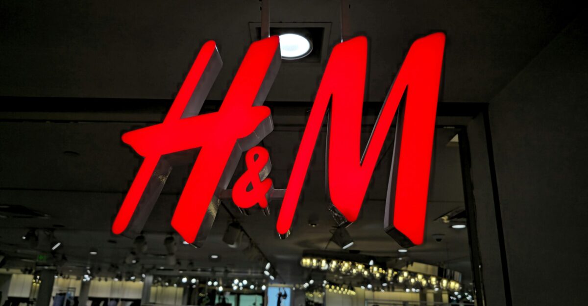 The illuminated h m logo glows brightly at night