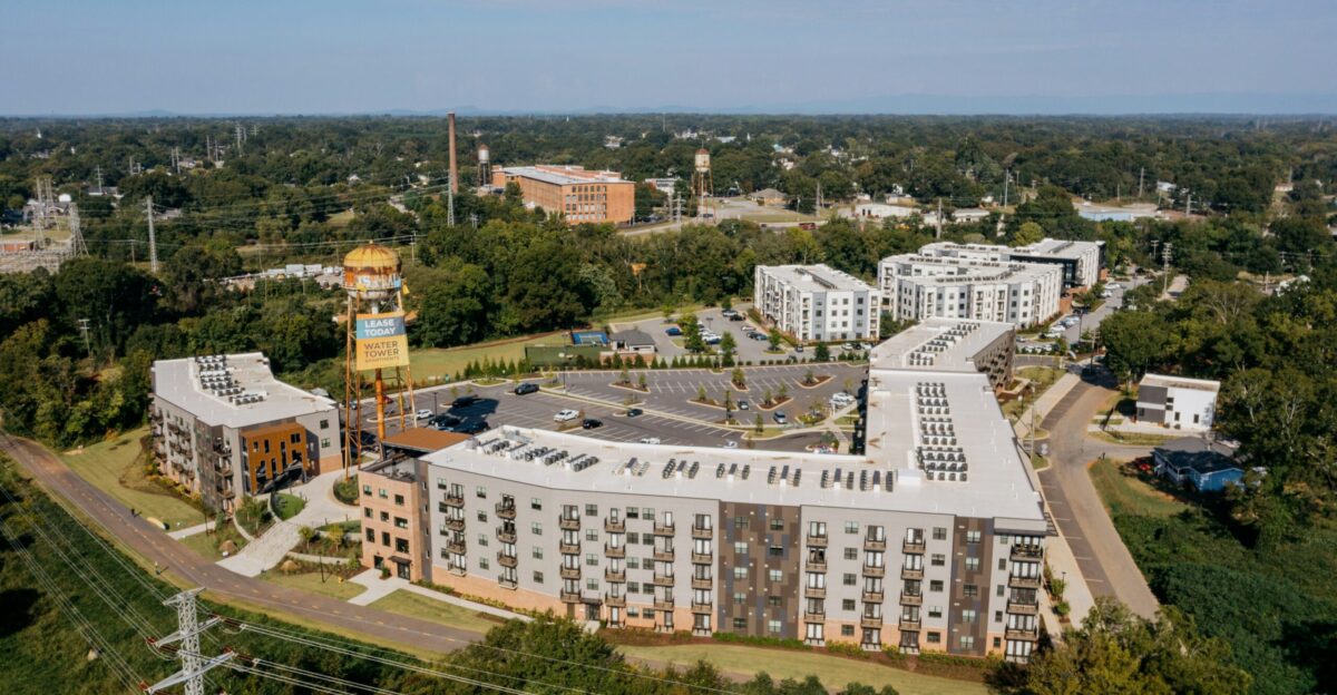Modern apartment buildings surrounded by trees and greenery