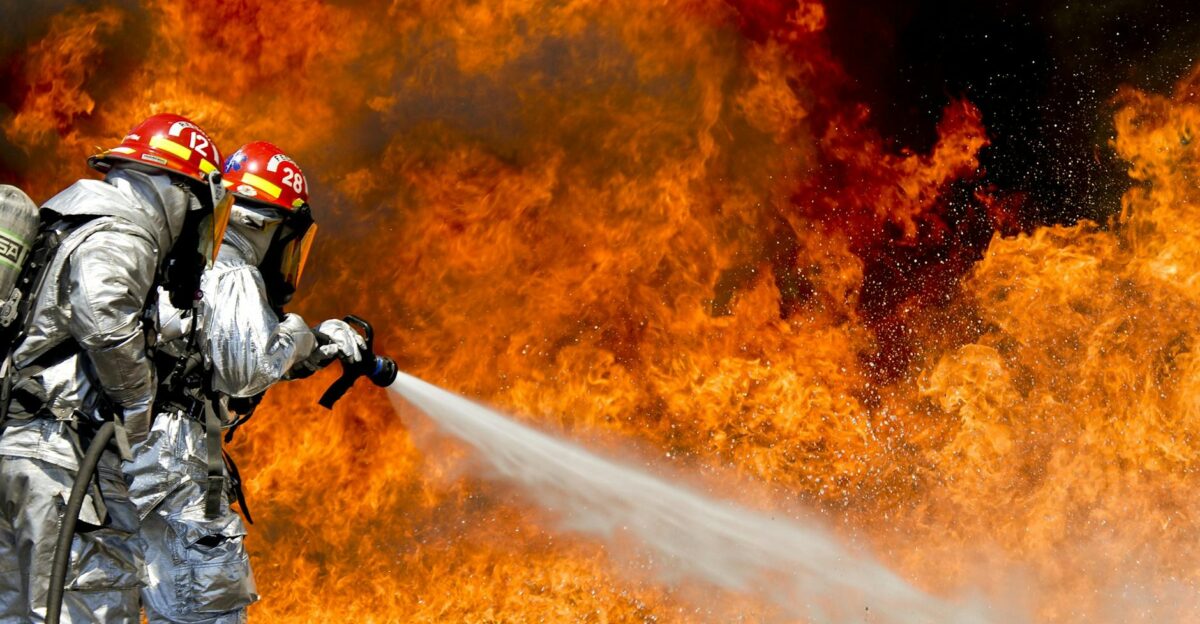 Brave firefighters in action extinguishing a large fire with determination and teamwork