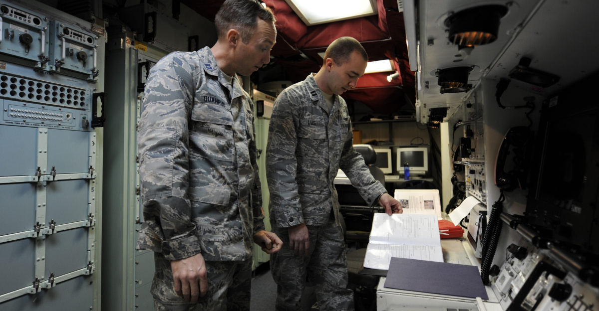 Capt. Andrew Quanrud, 576th Flight Test Squadron test operations officer, and Capt. Joseph Liles, 576th FLTS ICBM Field Test Management chief, review the procedures for installing a launch enable panel Feb. 26, 2015, during the Missile Alert Facility start-up for Glory Trip-214 and Glory Trip-215 at Vandenberg Air Force Base, Calif. The 576th plays a critical role in the operational test launch process, preparing facilities and equipment for the operational missile wings, which send missile crews to physically launch the unarmed Minuteman III missiles.