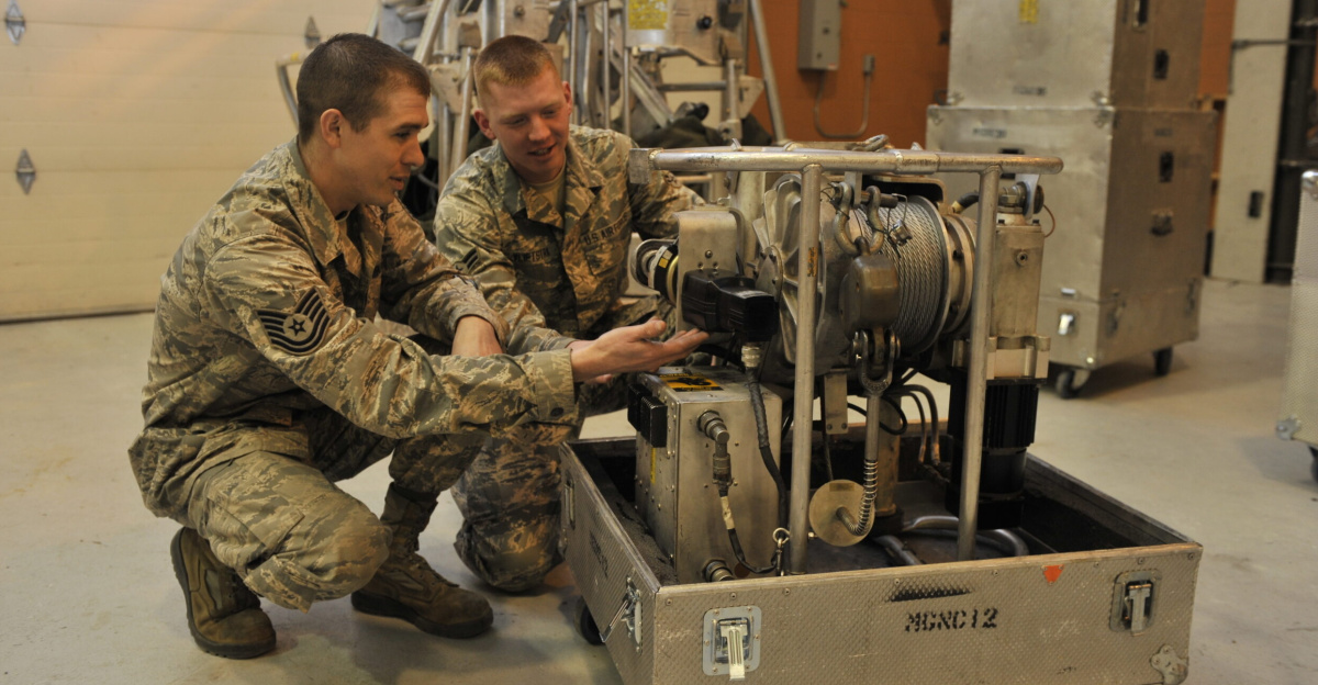 Tech. Sgt. Robert Richards, 341st Maintenance Operations Squadron mechanical and pneudraulics section team chief and team trainer, and Airman 1st Class Benjamin Vlietstra, 341st MOS power, refrigeration and electrical laboratory technician, look over a guided missile maintenance platform motor Jan. 21 at Malmstrom Air Force Base, Mont. All 17 of the 341st Missile Wing’s GMMPs—also known as work cages—were available for service on Jan. 14, ensuring that missile maintenance in Minuteman III launch facilities stays on schedule. (U.S. Air Force photo/John Turner)