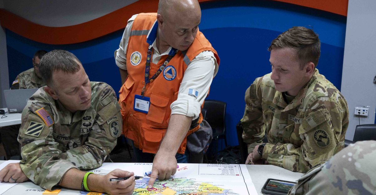 Joint Task Force-Bravo personnel and National Coordination for Disaster Reduction (CONRED) representatives discuss response options and plans to a simulated scenario during exercise Sentinel Watch at CONRED's National Emergency Operations Center in Guatemala City, Guatemala, Aug. 22, 2024. The second day of the exercise was the scenario-based portion based on Guatemala’s most devastating earthquake back in 1976 that was 7.5 in magnitude and a volcano eruption since Guatemala is one of the highest ranked areas for geological hazards. (U.S. Air Force photo by Staff Sgt. Shelby Pruitt-Johnson)
