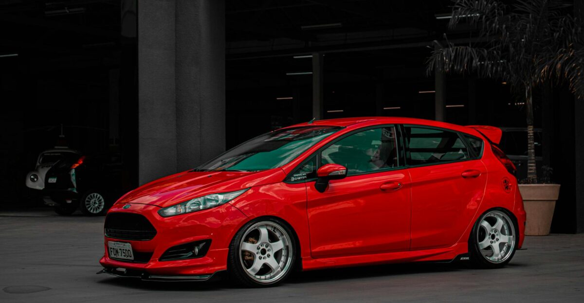 A stylish red Ford Fiesta parked in an urban setting showcasing modern automotive design